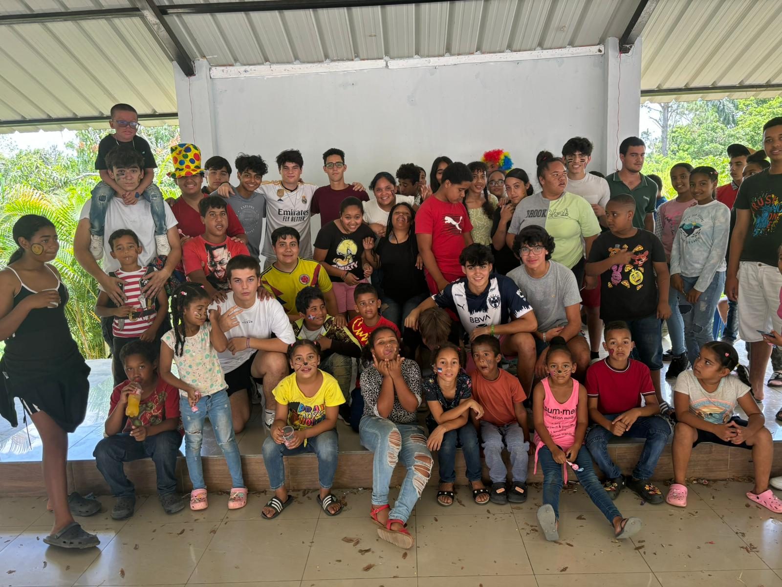 Volunteers and children gathered together at a community visit in the Dominican Republic